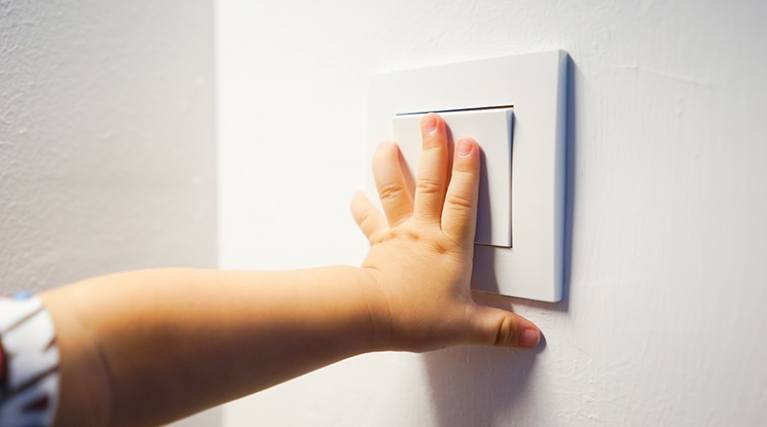 Hand switching on a light switch