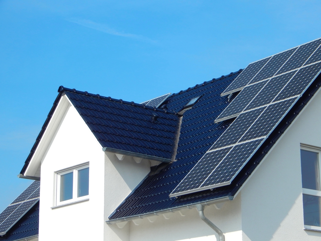 Ten black solar panels on roof of detached home 